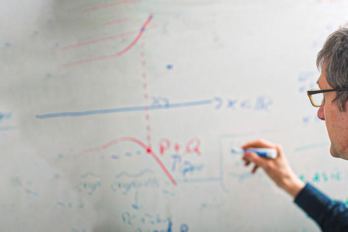Researcher writing on a white board